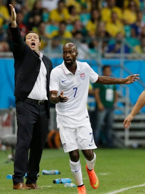 Belgium's head coach Marc Wilmots gestures during the World Cup round of 16 soccer match between Belgium and the USA at the Arena Fonte Nova in Salvador, Brazil, Tuesday, July 1, 2014. At right isUnited States' DaMarcus Beasley. (AP Photo/Matt Dunham)