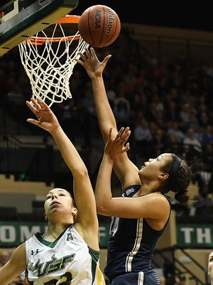 Connecticut forward Napheesa Collier takes a shot over South Florida guard Laia Flores during the first half at USF Sun Dome in Tampa.