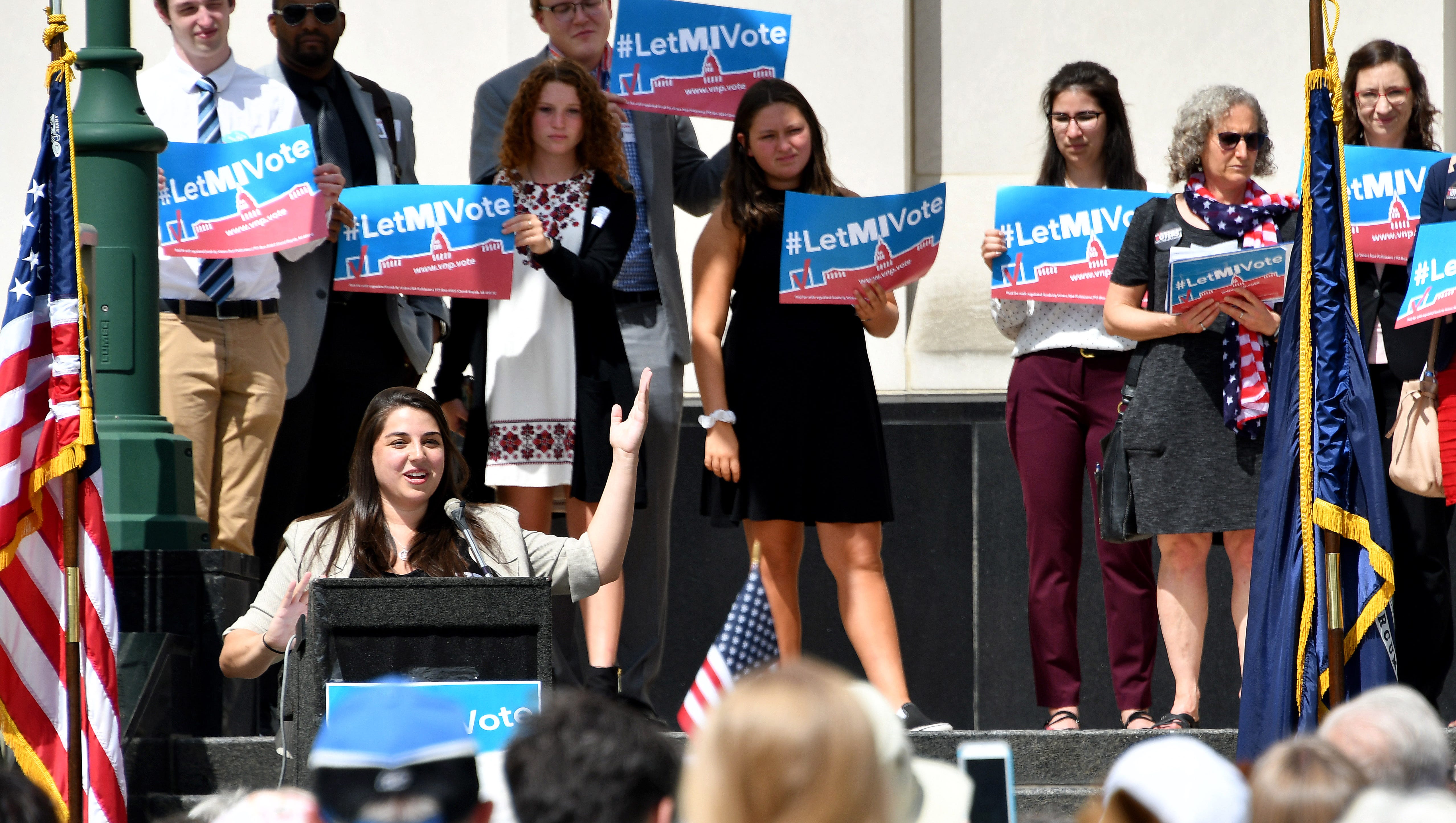 Katie Fahey talks to demonstrators as they rally outside the Michigan Hall of Justice Wednesday, July 18, 2018, where the Michigan Supreme Court heard arguments on whether the constitution should be amended by voters to change the way political districts are made.