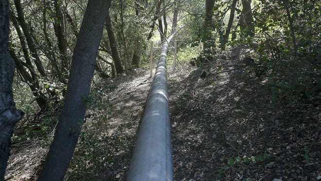In a remote area of the San Bernardino forest, a pipe hisses with the sound of mountain springs water it carries to Nestle North America's tanks below where its then transported to Ontario for bottling.