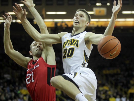 Iowa's Jarrod Uthoff draws a foul from Rutgers' Stephen