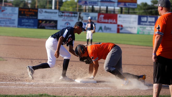 Flat Bill's Michael DeHerrera retreats back to first base against Strike Zone's Marley Descheney during a City League baseball game on Wednesday, July 11 at Ricketts Park. Flat Bill will face the Rivercats in Tuesday's City Tournament opener.