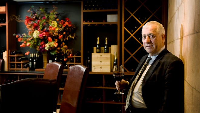 Restaurateur Aldo Lamberti holds a glass of wine at his restaurant Caffe Aldo Lamberti in Cherry Hill.