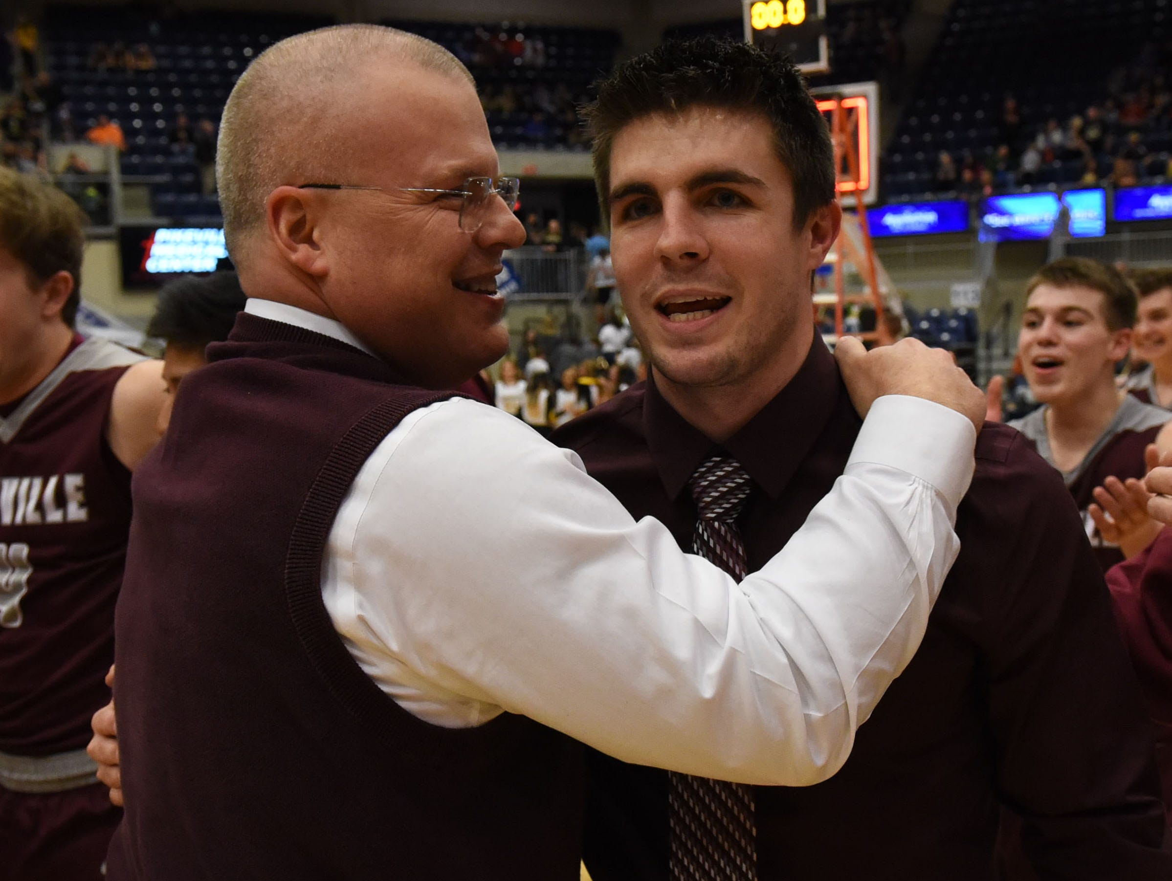 Pikeville Schools superintendent Jerry Green (left) and Pikeville coach Elisha Justice celebrate after Pikeville's win over Johnson Central in the 15th Region Tournament championship game on March 6.