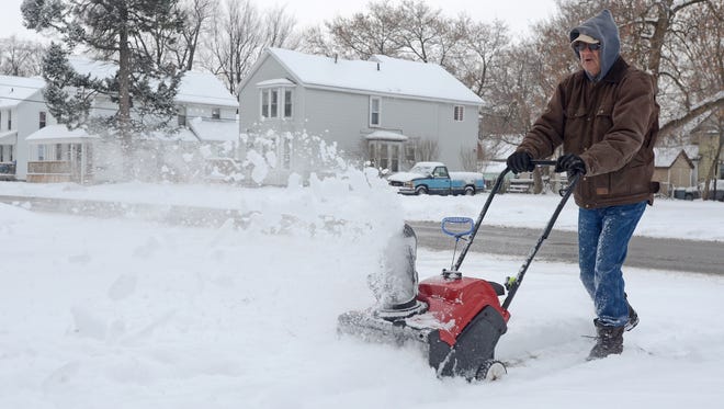Bob Tremble removes snow from the sidewalk with his snowblower Monday, Jan. 4, in Port Huron.