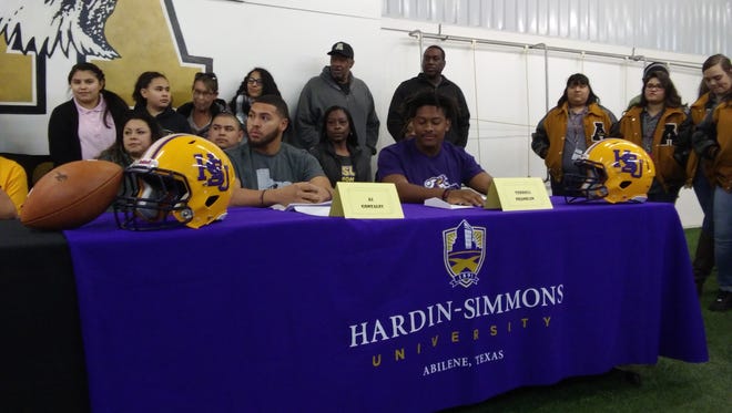 Abilene High linebackers A.J. Gonzales, left, and Terrell Franklin wait to give their commitments to Hardin-Simmons during a National Signing Day ceremony Wednesday at Abilene High School.