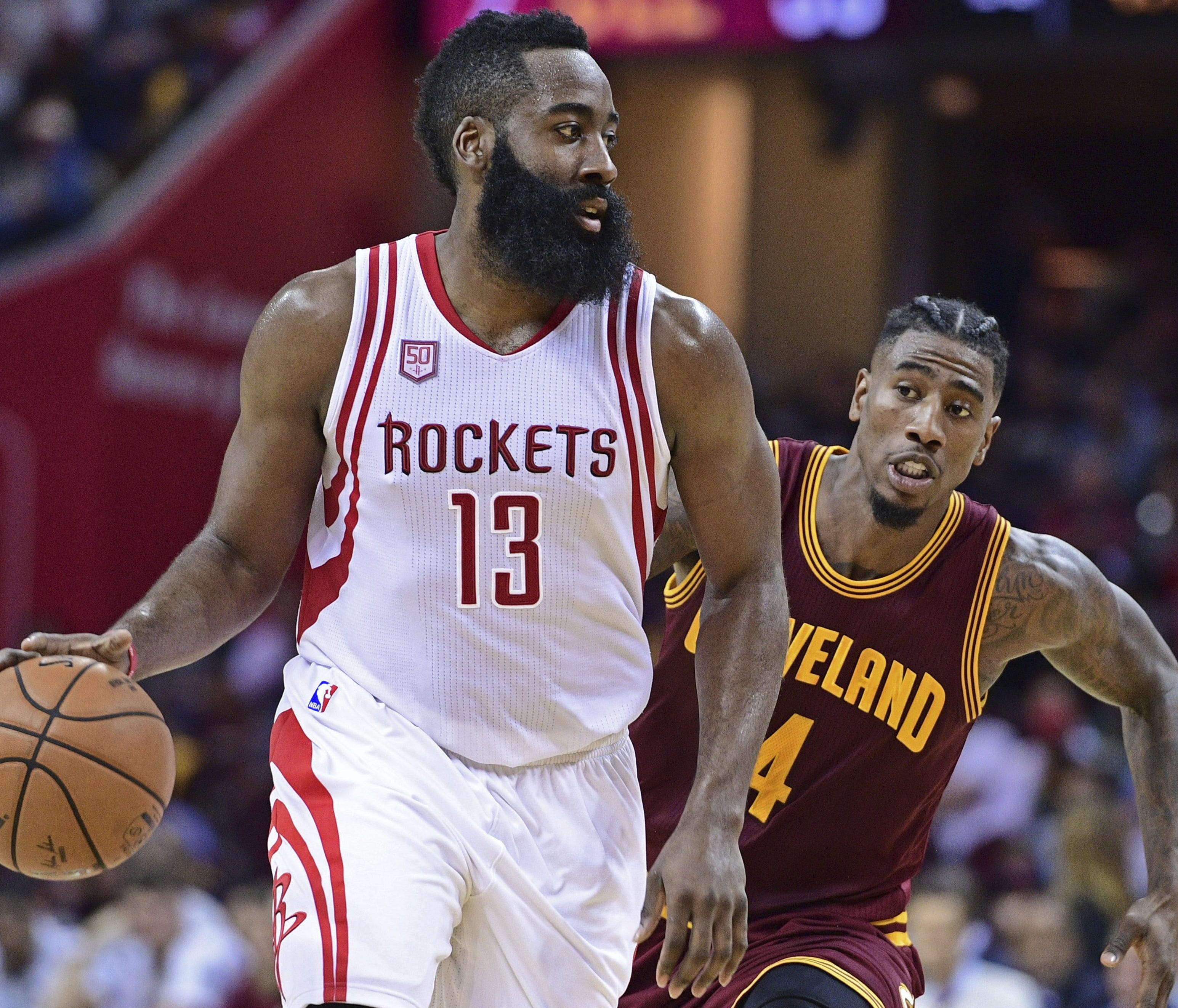 Houston Rockets guard James Harden (13) dribbles as Cleveland Cavaliers guard Iman Shumpert (4) closes in during the first half of an NBA basketball game Tuesday, Nov. 1, 2016, in Cleveland. (AP Photo/David Dermer) ORG XMIT: OHDD105