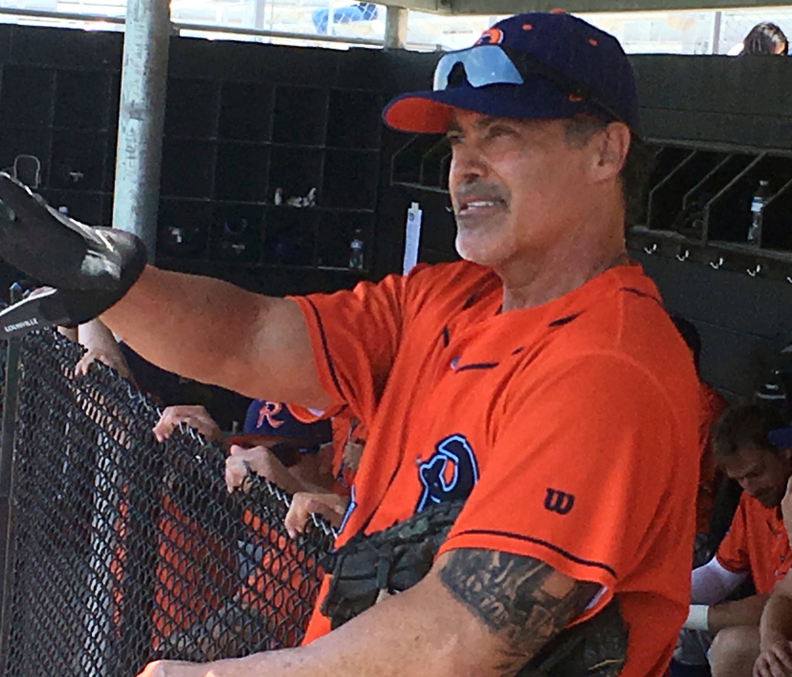 Cleburne Railroaders newly signed player and former Major League player, Rafael Palmeiro watches play from the dugout before heading back on the field during a spring training baseball game in Cleburne, Texas.