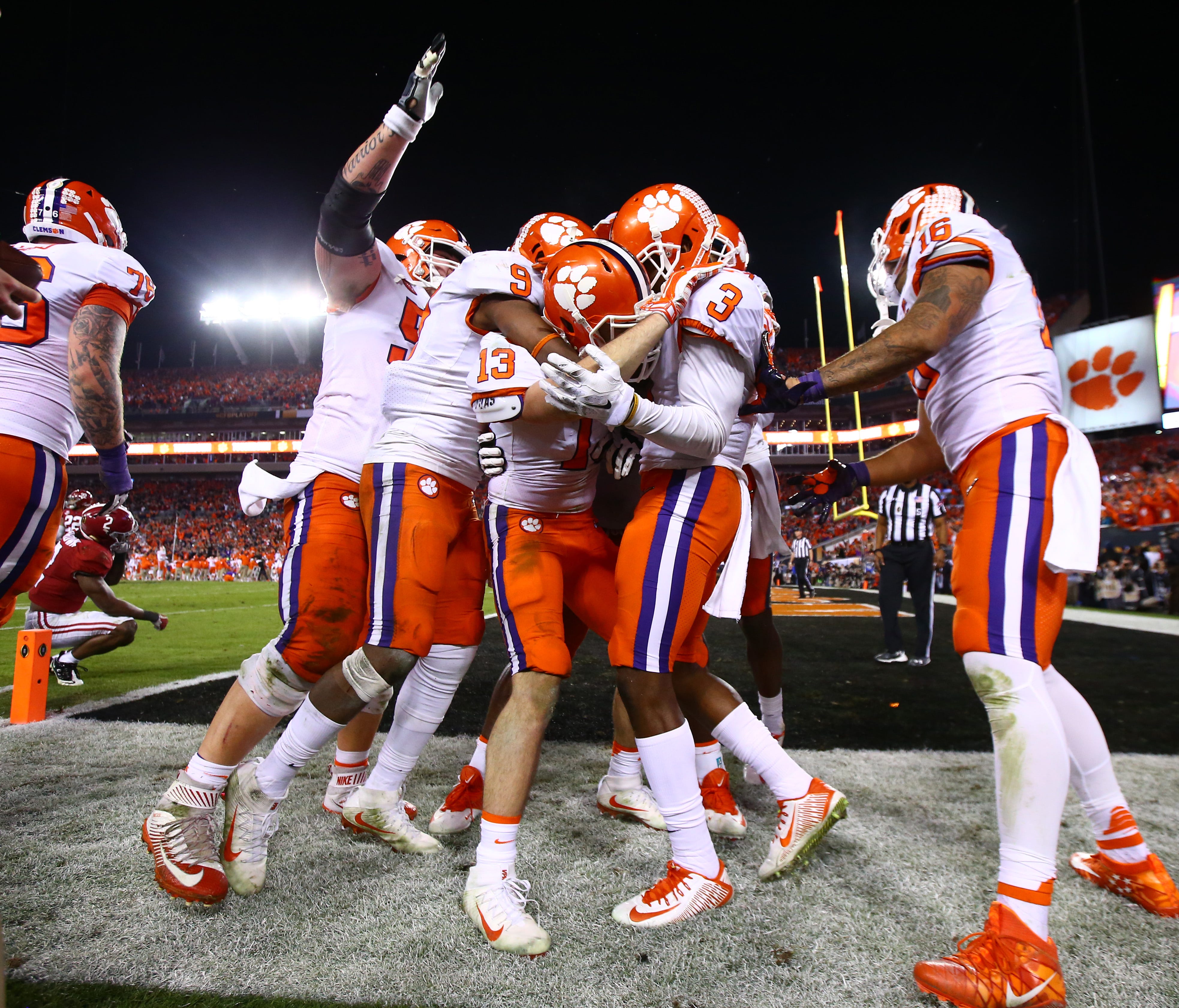 The Clemson Tigers celebrate with wide receiver Hunter Renfrow (13) after scoring the game winning touchdown against the Alabama Crimson Tide in the 2017 College Football Playoff National Championship Game at Raymond James Stadium.