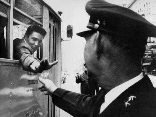 Elvis Presley on the day of his induction into the U.S. Army on March 24, 1958. He is shown leaving Downtown Memphis on the bus that will take him to Kennedy Veterans Hospital.