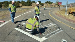 New Mexico Department of Transportation contractors install directional arrows and reflectors Wednesday on a ramp at Interstate 25 and U.S. 285 near Eldorado. The safety measures are supposed to help prevent wrong-way driving.