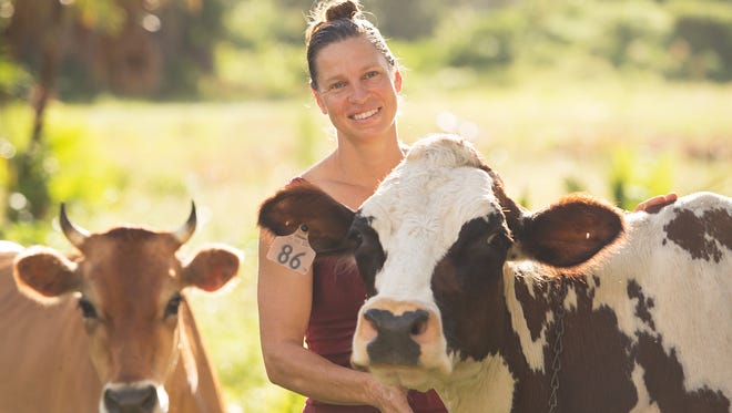 Suzie Dudas, owner of Jupiter Creamery, with Bacardi, one of her dairy cows at Jupiter Creamery in Jupiter.