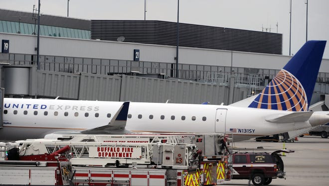 Emergency vehicles surround a SkyWest Airlines plane, operating as United Express, that made an emergency landing at Buffalo Niagara International Airport, Wednesday, April 22, 2015, in Cheektowaga, N.Y.