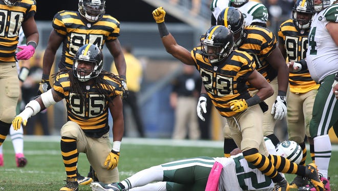 Pittsburgh Steelers outside linebacker Jarvis Jones (95) and free safety Mike Mitchell (23) react after a stop against New York Jets running back Matt Forte (22) during the third quarter at Heinz Field. The Steelers won 31-13.
