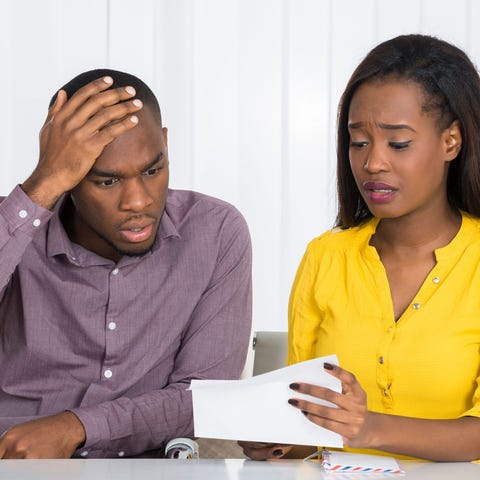 African American couple looking at financial paper