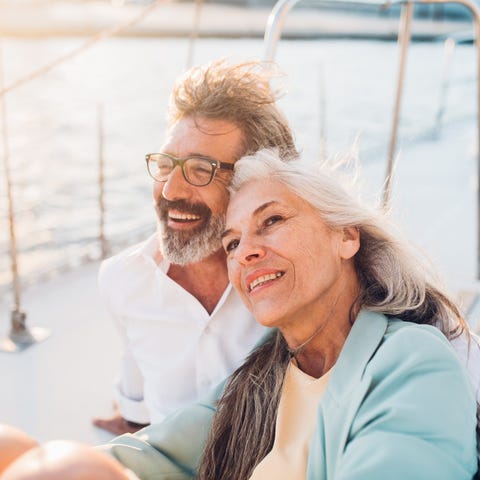 Smiling senior couple sitting on a boat.