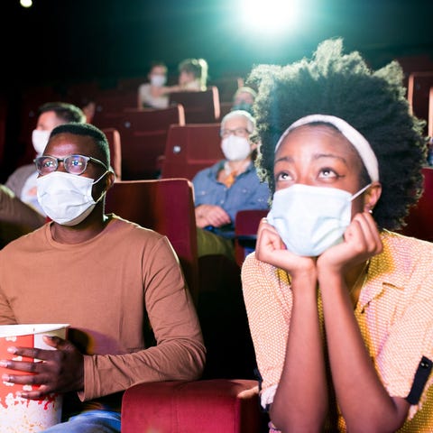Theater goers masked up at the movies.