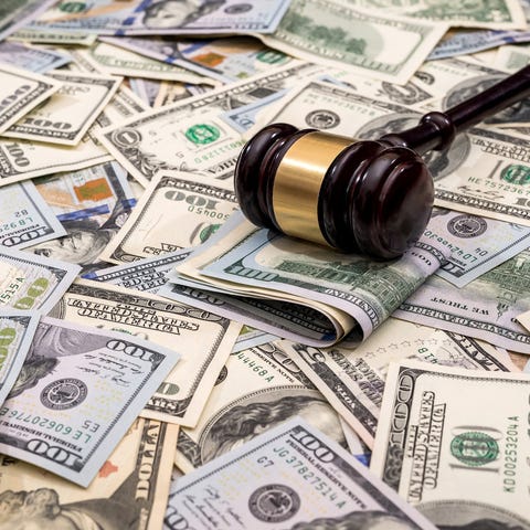 Gavel atop a pile of money.