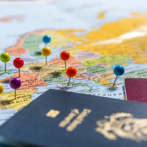 Passports on map with pins in European cities.