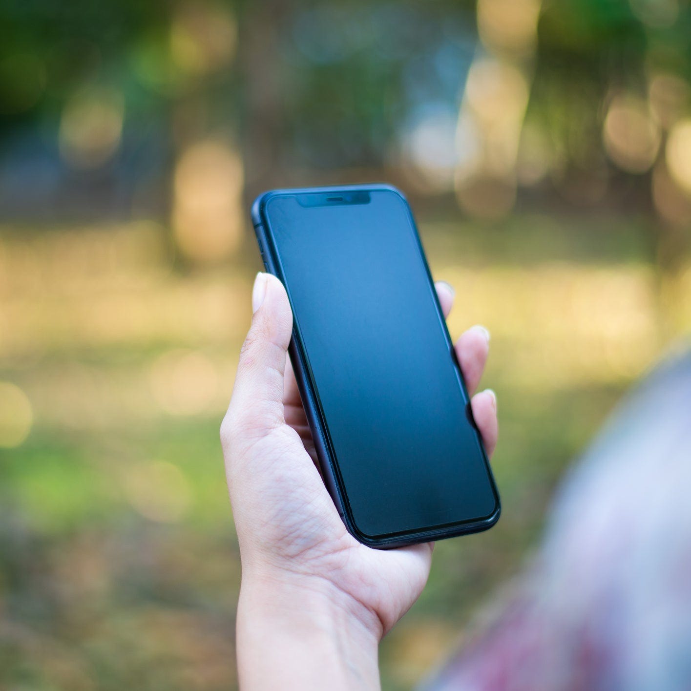 A person holding an iPhone.