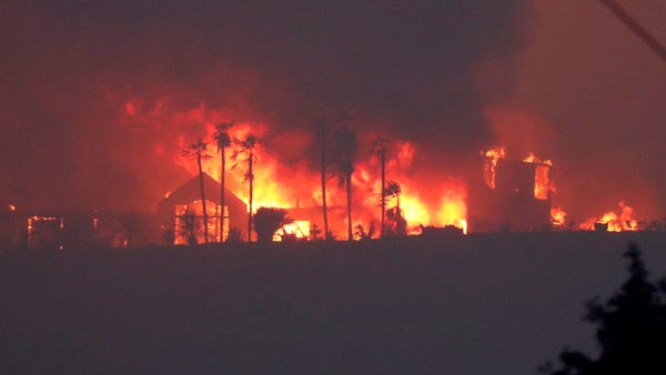 A luxury home taken over in flames from the River Fire