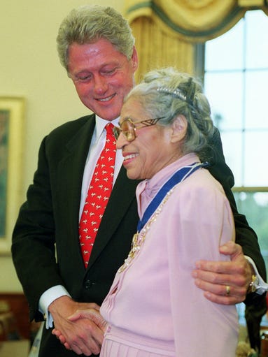 President Bill Clinton smiles with Rosa Parks in the