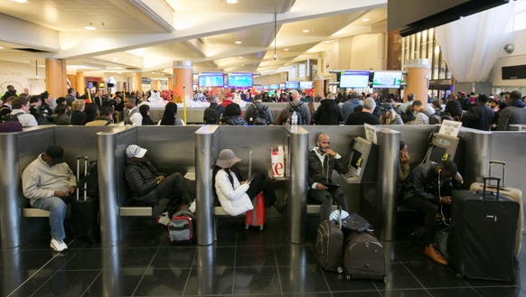 Stranded passengers relax near baggage claim at Hartsfield-Jackson