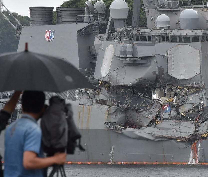 A TV crew films the damages on the guided missile destroyer USS Fitzgerald at its mother port in Yokosuka, southwest of Tokyo on June 18, 2017.