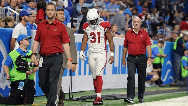 Arizona Cardinals running back David Johnson (31) walks off the field with medical staff for X-rays during an NFL football game against the Detroit Lions in Detroit, Sunday, Sept. 10, 2017.