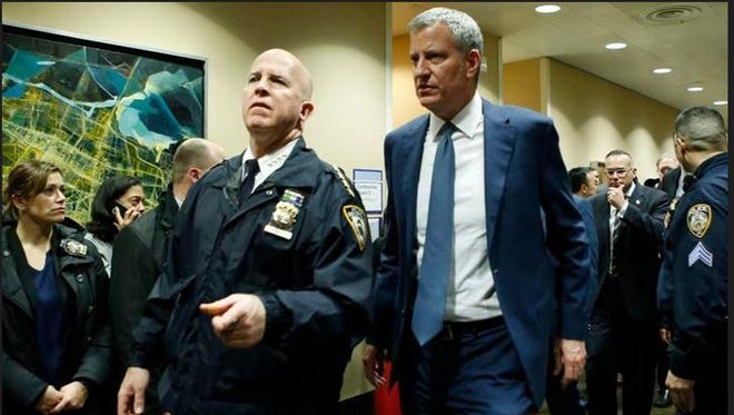 New York City Mayor Bill de Blasio, right, is escorted by New York City Police Department Chief of Department James P. O'Neill, into the emergency wing at Lincoln Hospital Thursday, Feb. 4, 2016, after NYPD Officer Patrick Espeut of Southeast and another officer were shot in a public housing project in the Bronx during an altercation with several suspects, one of whom apparently turned the weapon on himself.