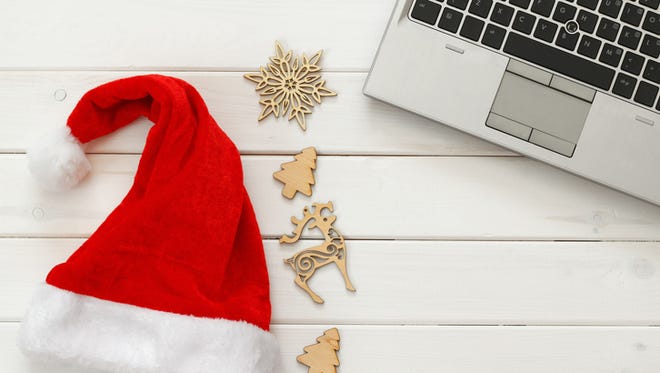 On line christmas holiday shopping concept. Santa claus red hat next to computer keyboard