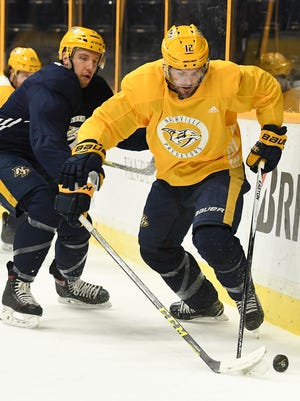 Predators center Mike Fisher (12) battles for the puck with center Nick Bonino (13) during a morning practice at Bridgestone Arena Monday, Feb. 12, 2018 in Nashville, Tenn. Fisher has rejoined the Nashville Predators after coming out of retirement.