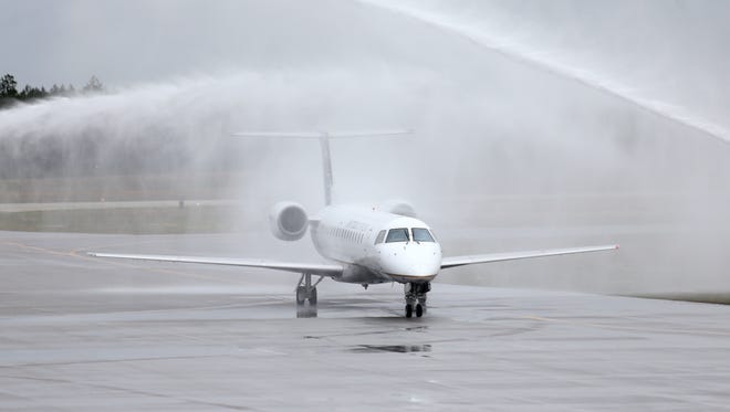 The inaugural United Express flight is given a water-cannon salute at the Northwest Florida Beaches International Airport on March 5, 2015.