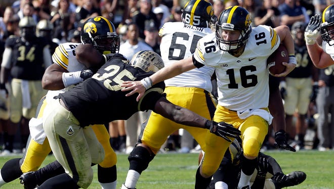 Iowa quarterback C.J. Beathard tries to elude Purdue tacklers in a 24-10 win on Sept. 27 in West Lafayette, Ind.