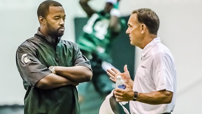MSU director of college advancement and performance Curtis Blackwell, here with football coach Mark Dantonio, is a critical piece behind MSU's massive upcoming recruiting weekend.