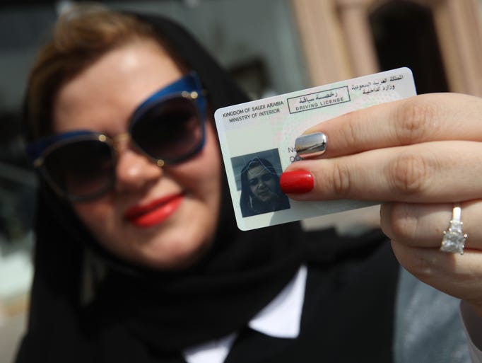 Nada Edlibi holds up her Saudi Arabian driver's license
