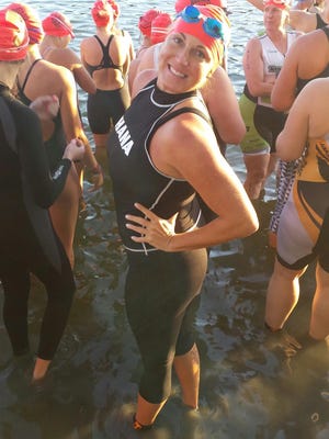 Michelle Mulak was all smiles before hopping into the lagoon for the open water swim portion of the Ron Jons Cocoa Beach Triathlon on Sunday.