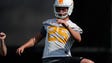 Aaron Medley (25) warms up during spring training at