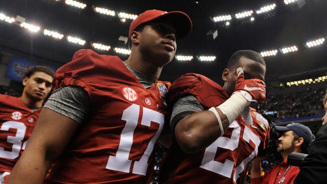Alabama running back Kenyan Drake (17) and defensive back Nick Perry (27) walk off the field after loosing to Ohio State during the Allstate Sugar Bowl at the Mercedes Benz Superdome in New Orleans, La. on Thursday January 1, 2015.