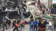 People search for survivors in a collapsed building