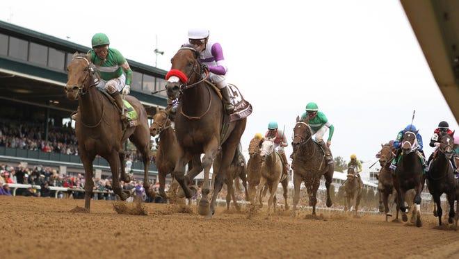 Nyquist, in white and purple, wins the Sentient Jet Breeders' Cup Juvenile at Keeneland. Oct. 31, 2015