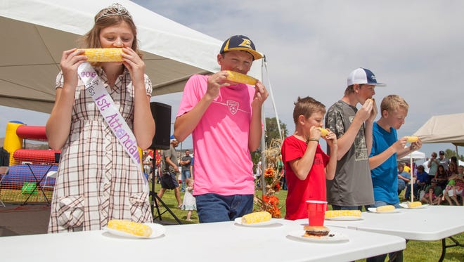 Contestants compete in a corn-eating contest during the annual Enterprise Cornfest on Saturday.