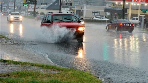 Traffic moves slowly along South Broadway Avenue as a heavy thunderstorm moves through the area, Tuesday, March 8, 2016 in Tyler, Texas. Powerful storms dumped heavy rain on parts of Texas, Arkansas and Oklahoma on Tuesday, causing flooding that led to a school bus rescue, property damage from suspected tornadoes and the death of a boater whose canoe capsized in strong winds. (Andrew D. Brosig/Tyler Morning Telegraph via AP) MANDATORY CREDIT