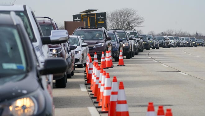 Cars line up to enter a COVID-19 drive-thru vaccination site Thursday at Jones Beach State Park in Wantagh, New York.