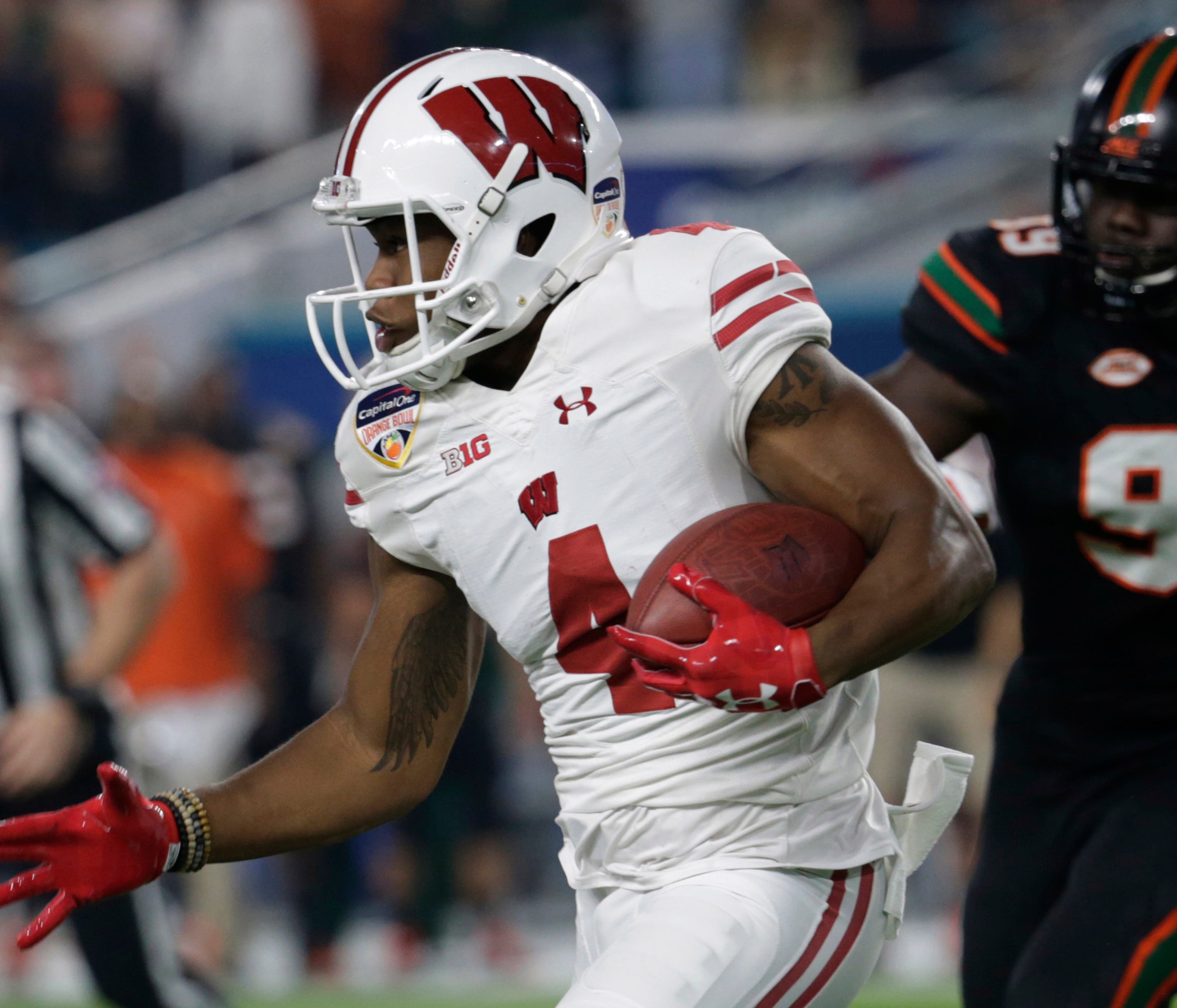 Wisconsin wide receiver A.J. Taylor (4) runs the ball, during the first half of the Orange Bowl NCAA college football game against Miami, Saturday, Dec. 30, 2017, in Miami Gardens, Fla. (AP Photo/Lynne Sladky) ORG XMIT: OTK