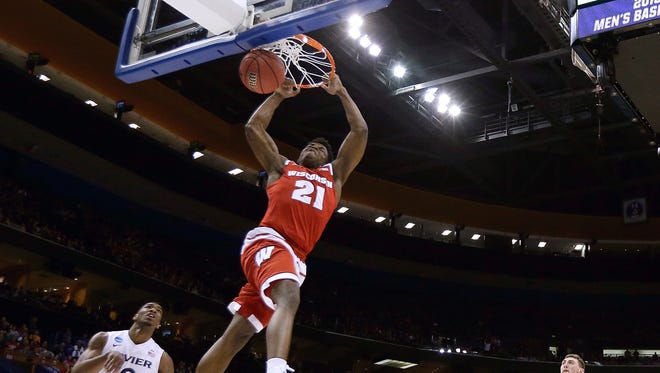 Wisconsin's Khalil Iverson (21) dunks the ball during the first half of a second-round men's college basketball game against Xavier in the NCAA Tournament, Sunday, March 20, 2016, in St. Louis. (AP Photo/Charlie Riedel)