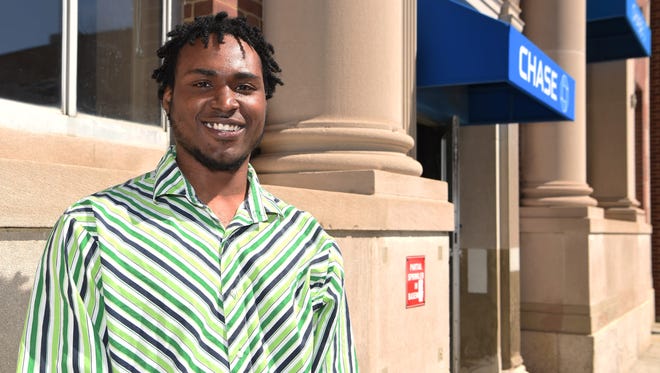 Dwayne Johnson, 21, of the Town of Poughkeepsie stands at the spot outside of a Chase Bank on Main Street in the City of Poughkeepsie where he saved man who overdosed by using a naloxone spray.  