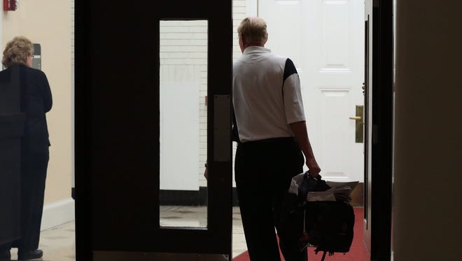 James Ramsey exits the building as the U of L Board went into open session Wednesday night.