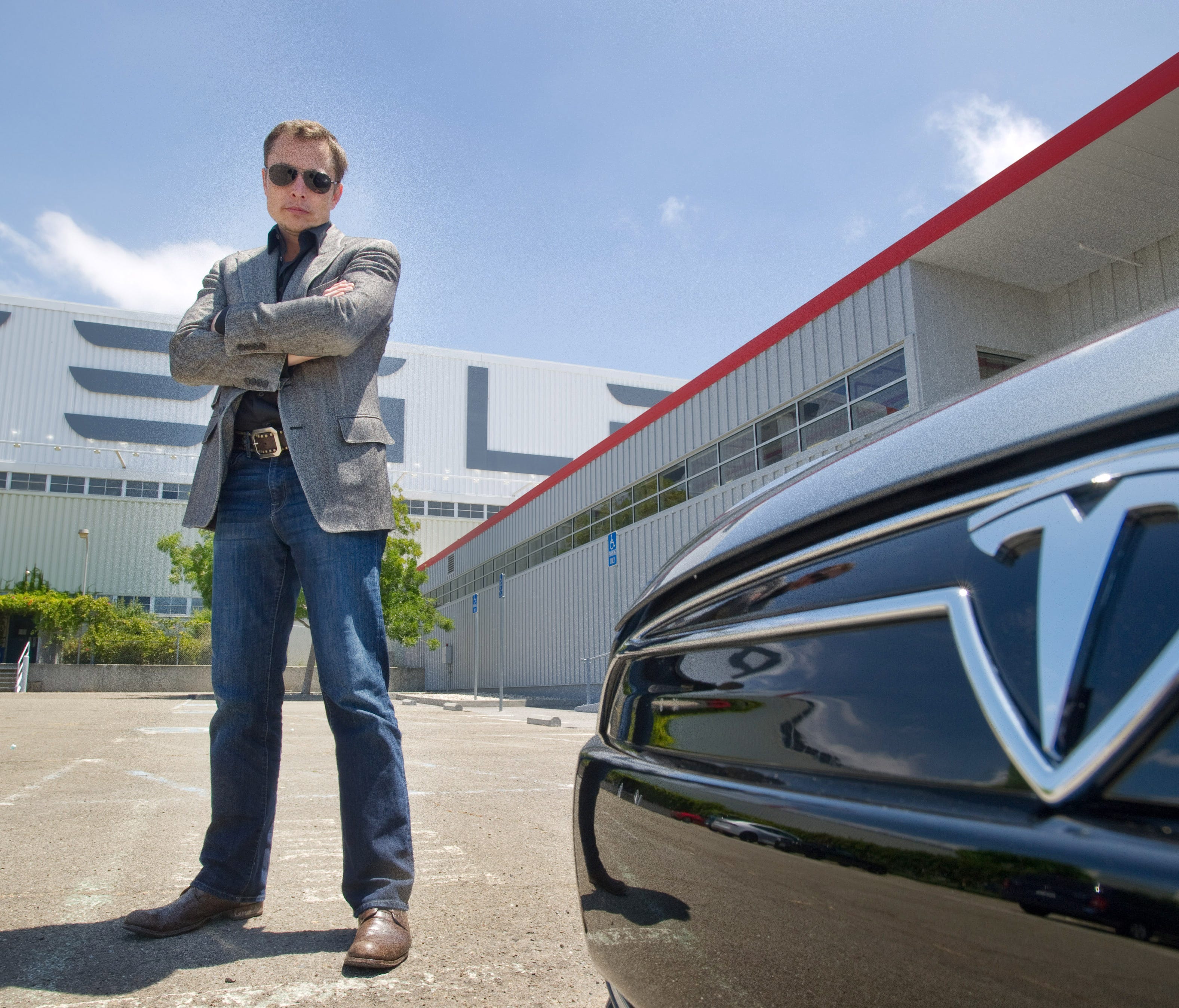 Elon Musk CEO, Cofounder, Chief Product Architect for Tesla with a new Model S  car outside the Tesla customer delivery area at the Tesla Fremont factory on June 21, 2012.