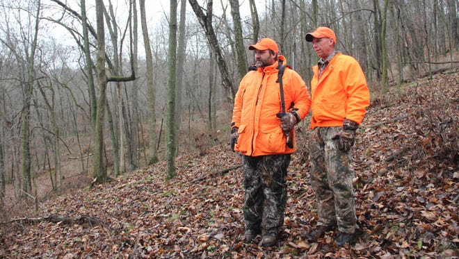 Mike Purnell of Oconomowoc (right) and Mark Morell of Oakfield look for signs of deer in a coulee in Richland County on Saturday, the opening day of the 2017 Wisconsin gun deer season.